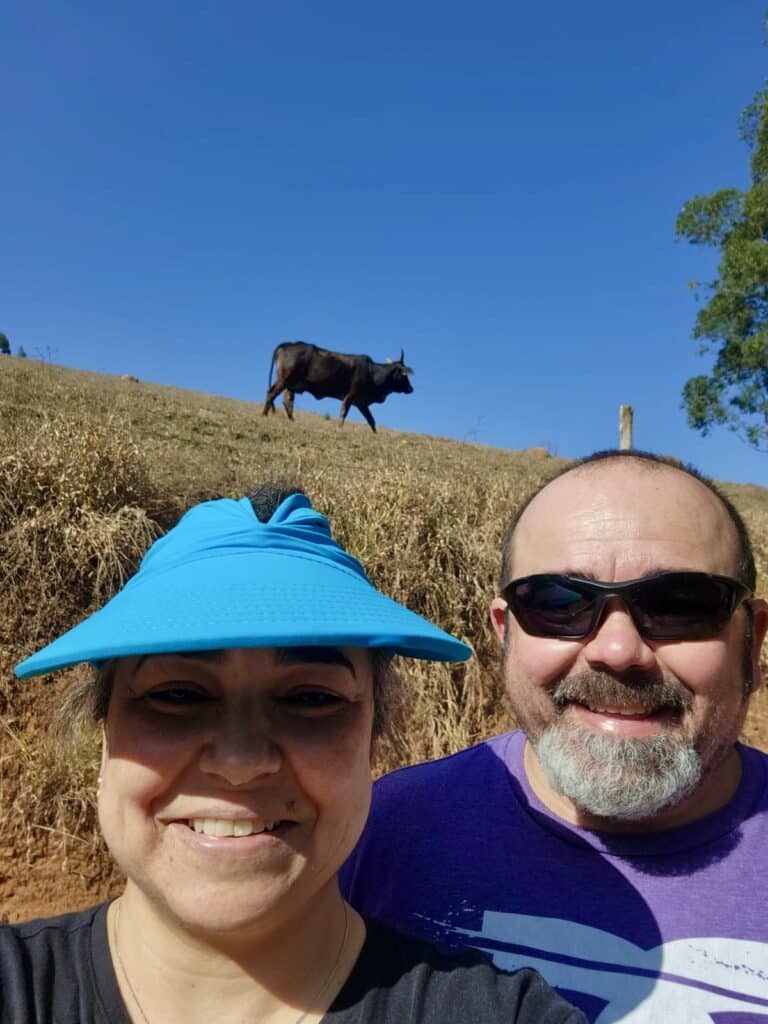 Roger Magalhaes, window treatment installer, with his sister and a cow in the background