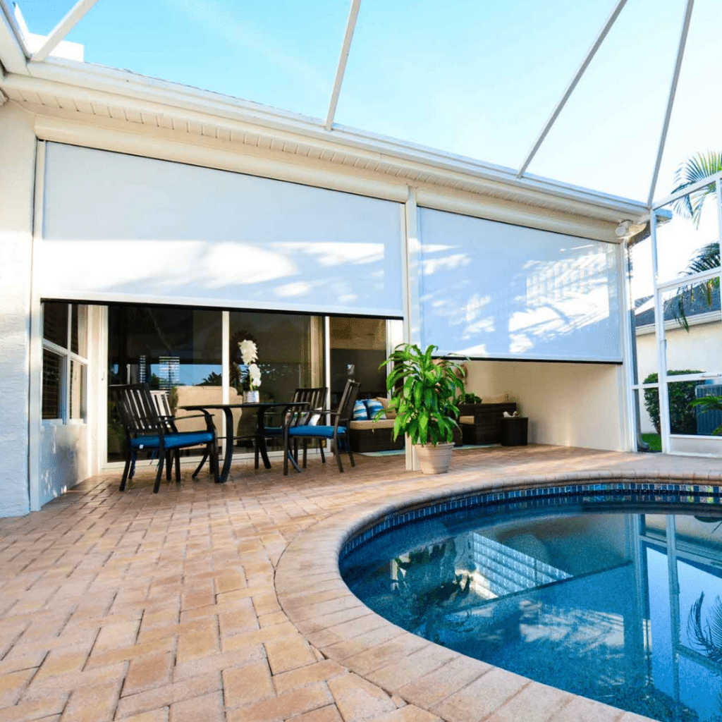 Screen roller shades positioned near the pool, offering privacy and protection from the sun while enhancing the outdoor space.