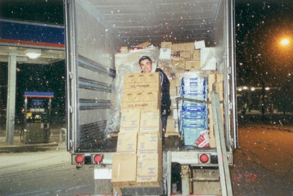 Roger Magalhaes unpacking boxes with a cart outside a truck, before becoming a window treatment installer.