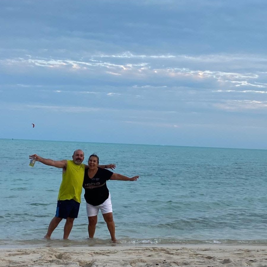 Roger and his wife enjoying a day at the beach in Turks and Caicos, celebrating their journey with Shades In Place.