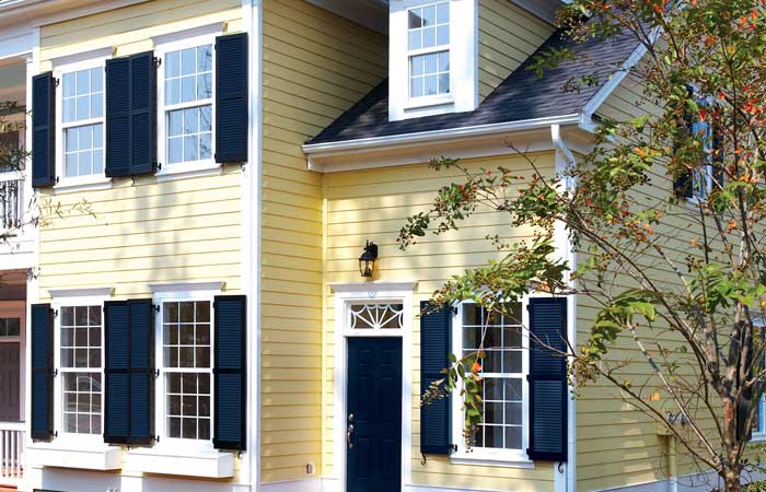 Colonial Shutters against a yellow house