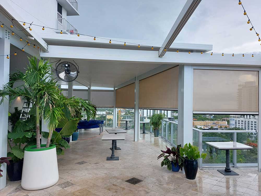 condo deck with screen coverings and plants on patio